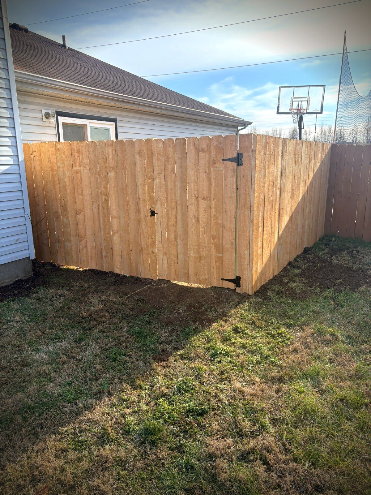 Metal fence panels along a residential property corner, built by Proper Deck & Fence in Franklin, TN.