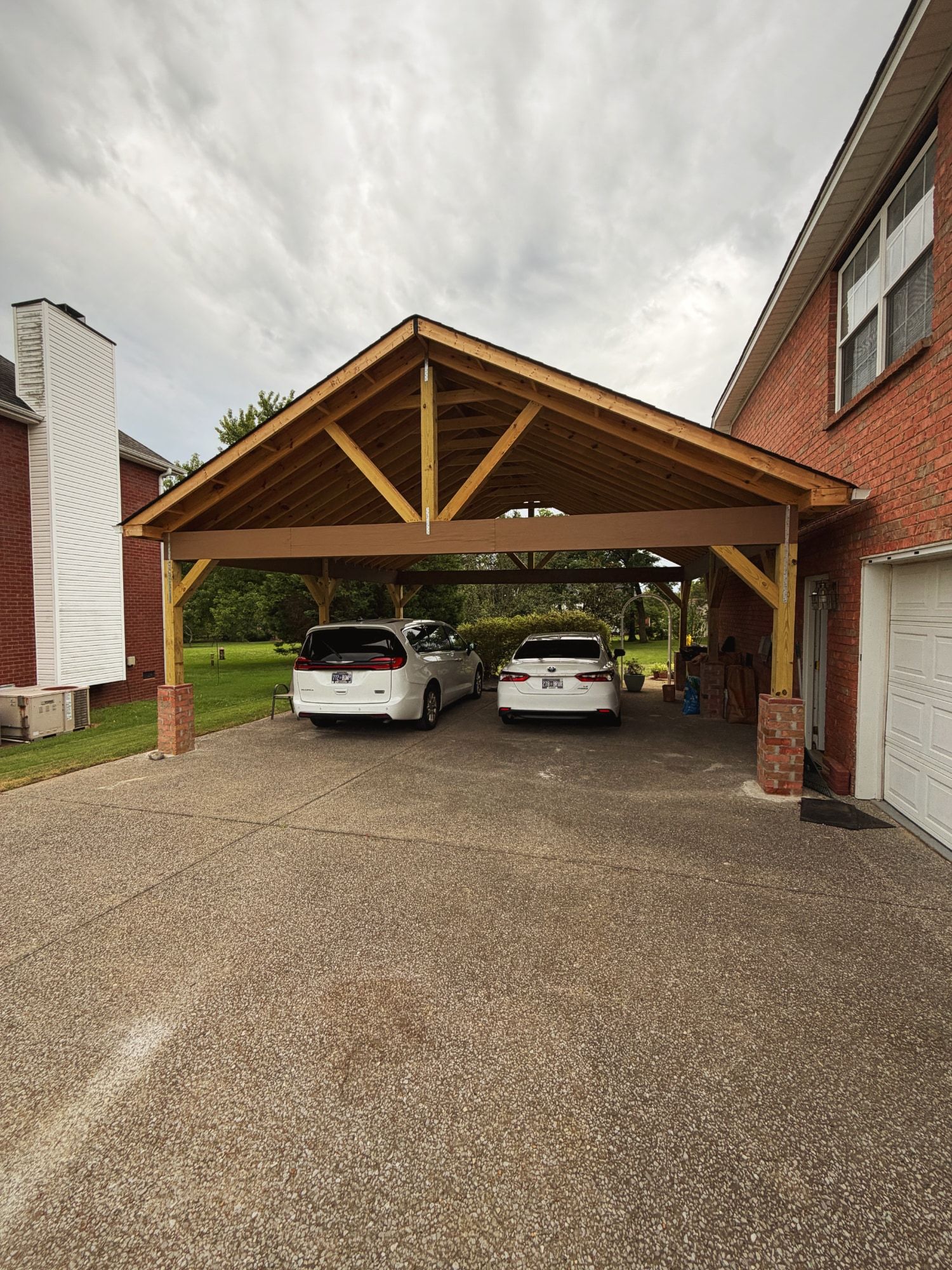 Gabled two-car carport with exposed timber trusses