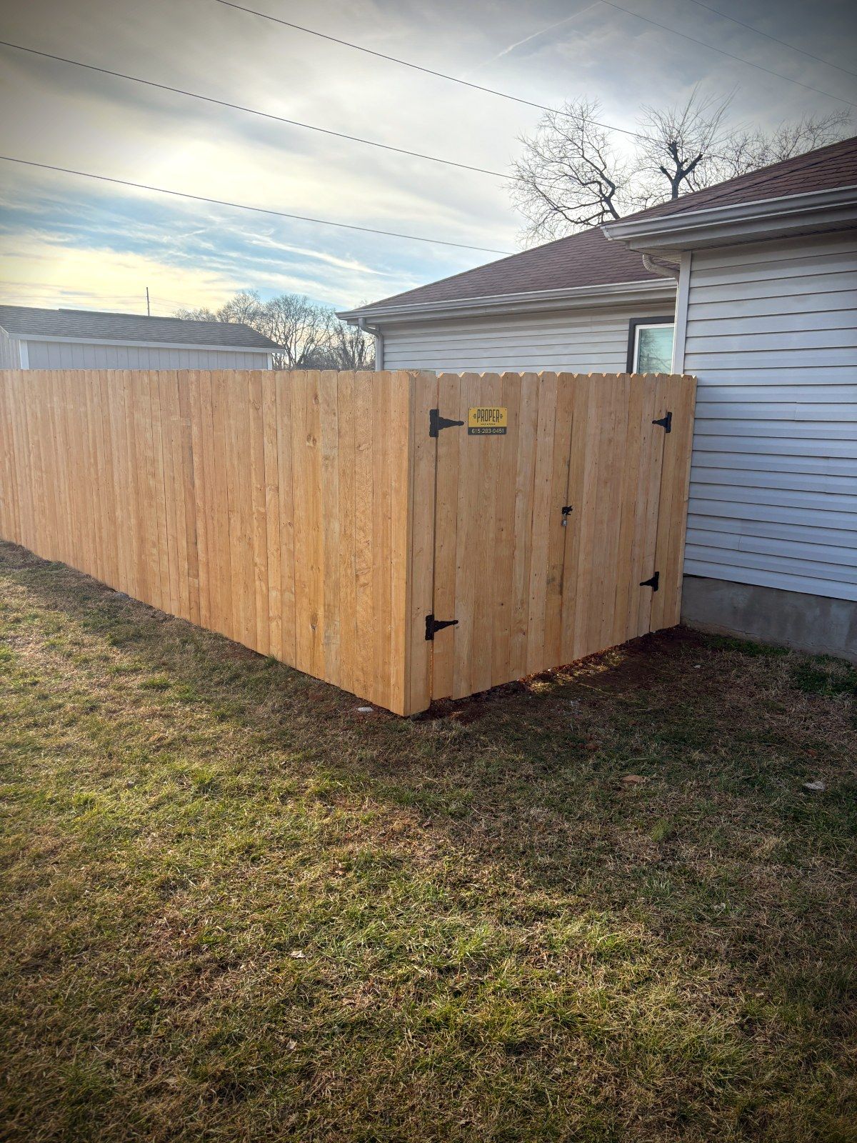 Wood privacy fence with branded gate