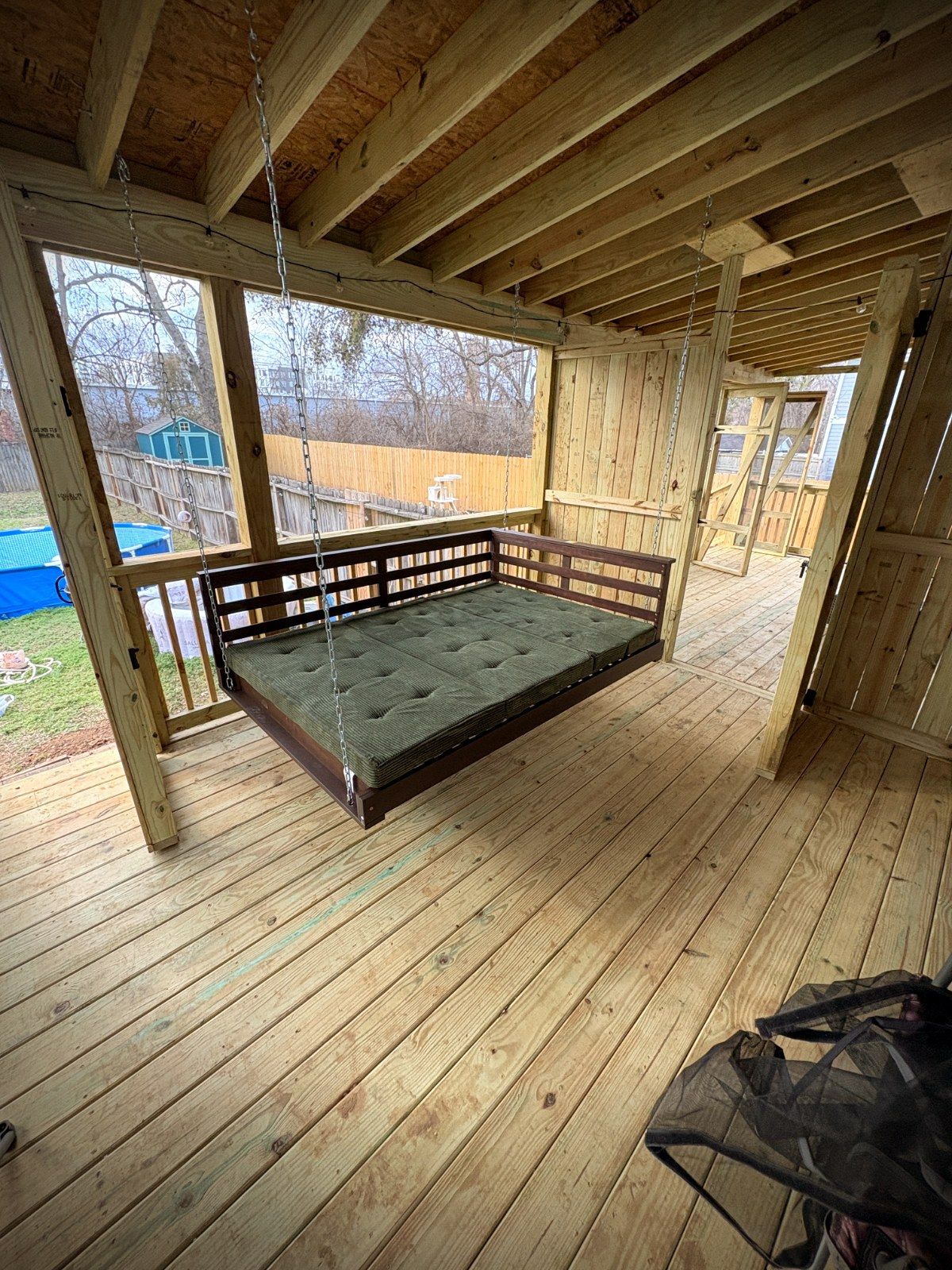 Screened porch with hanging swing bed